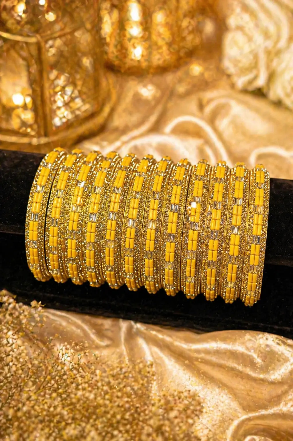 Elegant yellow gold kara bangles with intricate detailing and stone accents
