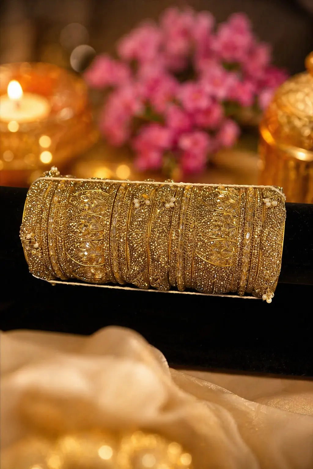 Gold bridal bangles set with intricate stone work detailing