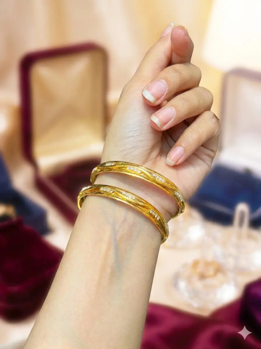Gold-plated zircon kara with slim design and sparkling stone detailing
