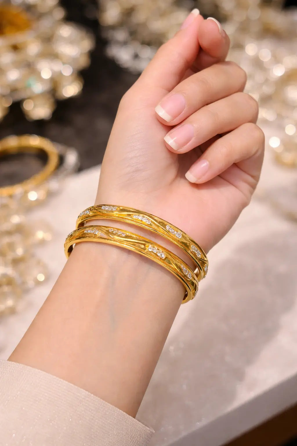 Gold-plated zircon kara with slim design and sparkling stone detailing