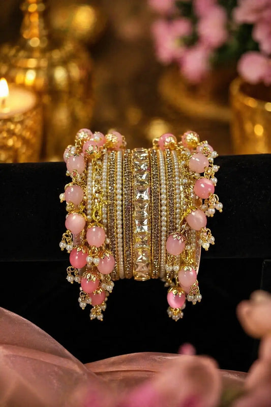 Pink pearl bridal bangles with gold accents and crystal detailing