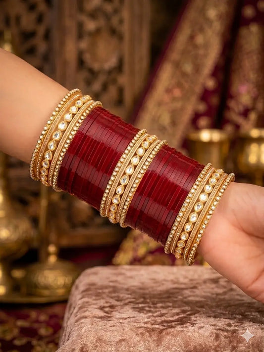 Red Punjabi Chura set with maroon bangles and gold Kundan accents