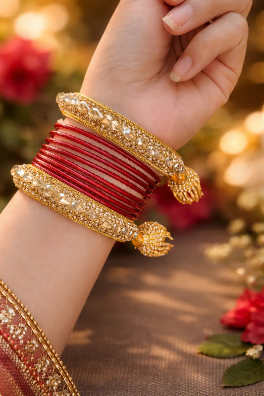 Red bridal Kundan kara set with gold detailing, embedded stones, and attached haathphool design paired with red bangles